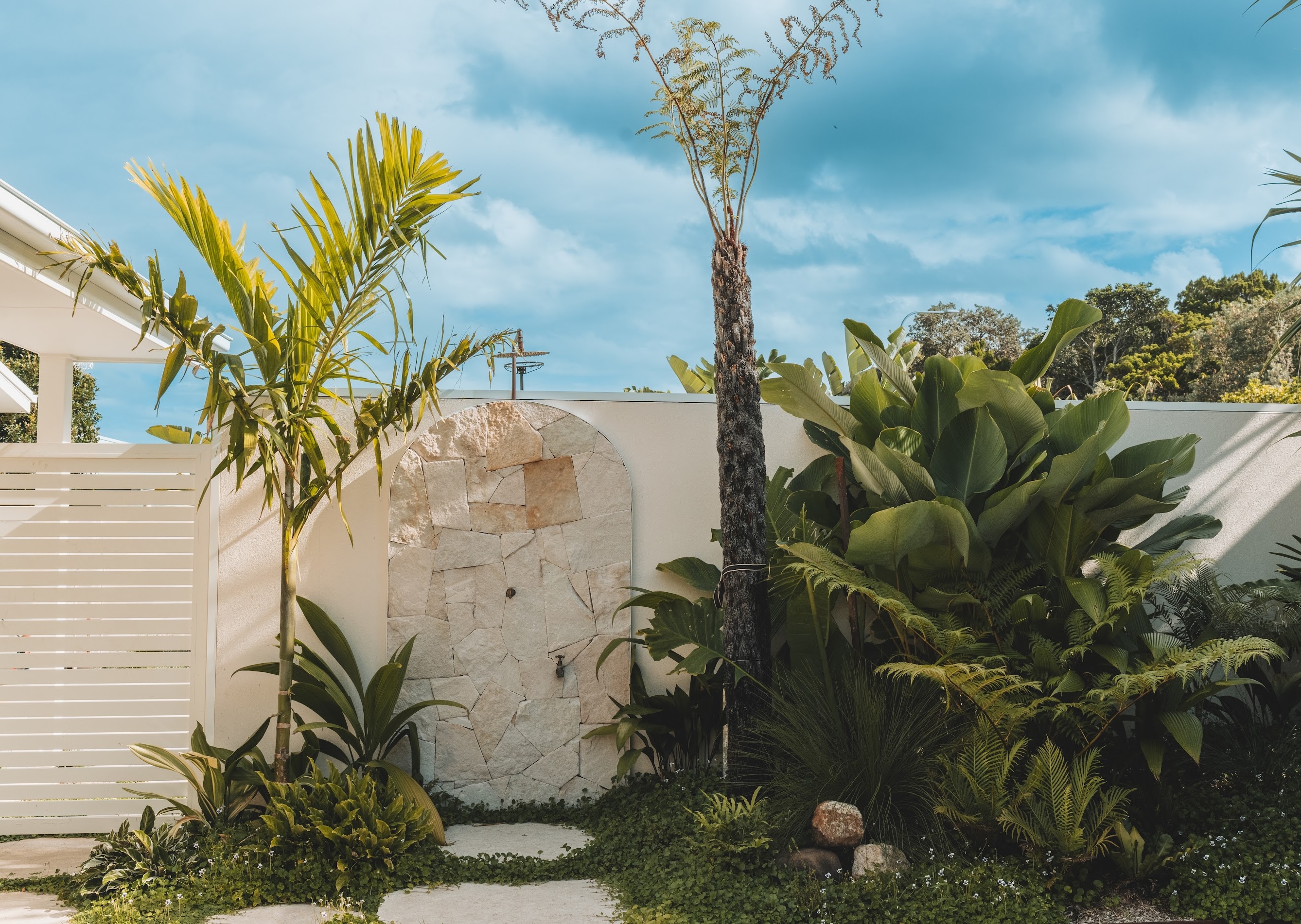 Outdoor shower enclosed by a subtropical planting, endemic to the region
